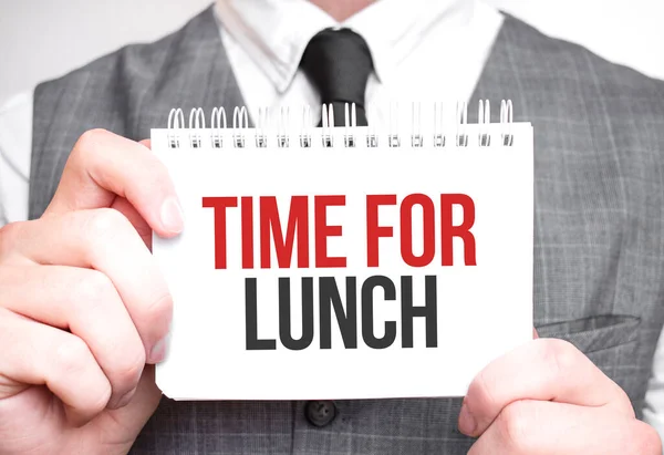 Businessman with notebook with text TIME FOR LUNCH