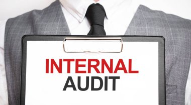 Elinde bir kağıt tutmakta olan bir iş adamı. İçişleri Bakanlığı 'ndan mesaj var.