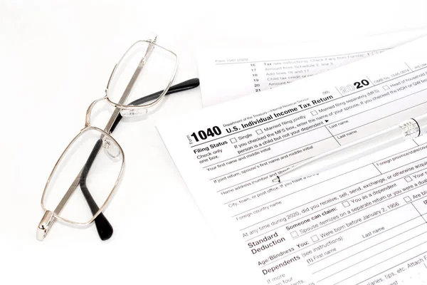 Income tax with instruction and glasses. Tax payment and filing concept