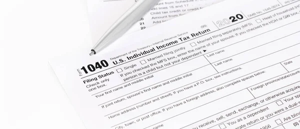 1040 Tax Form being filled out. Shallow depth of field