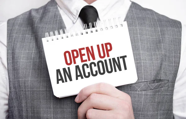 Businessman with notebook with text OPEN UP AN ACCOUNT