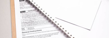 Tax form on paper folder and white notes