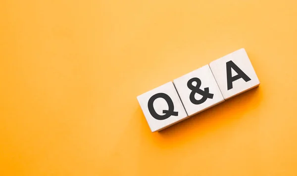 Q and A, questions and answers on wooden cubes. Concept