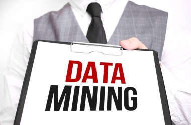 Elinde DATA Madencilik mesajı olan bir kağıt parçası tutan bir iş adamı.