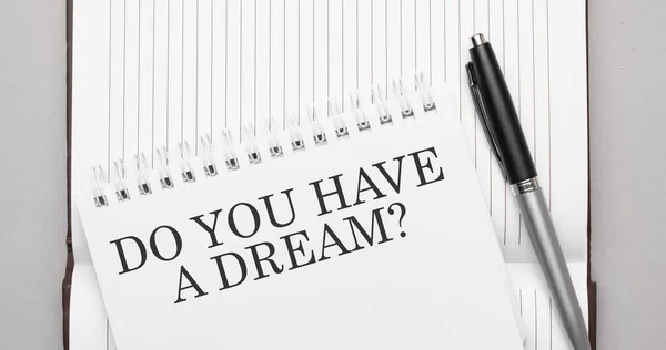 Words Do you have a dream text on notepad and pen