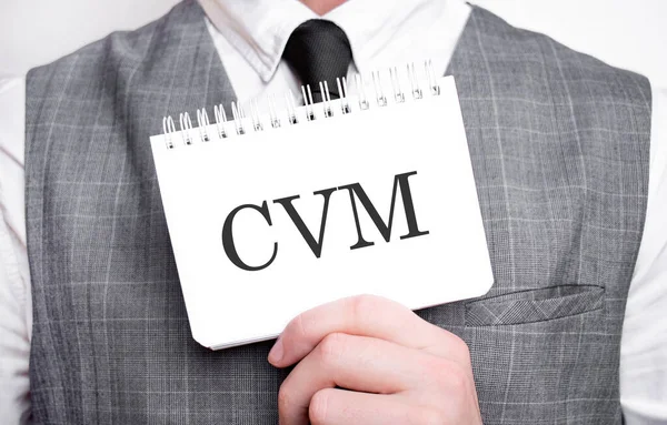 Businessman with notebook with text CVM . Business concept