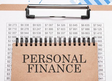Çizelgelerde ve numaralarda PERSONAL FINANCE yazan bir not. İş konsepti.