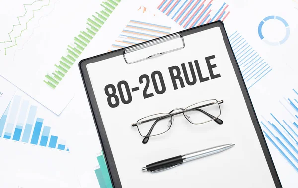 80 20 rule sign. Conceptual background with chart ,papers, pen and glasses