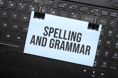 Dizüstü bilgisayar klavyesindeki beyaz kağıda yazılar ve gramer yazıları. Kapatma iletisi.