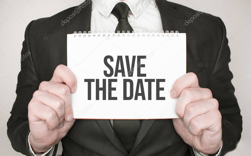 Businessman holding a notepad with text Save the Date