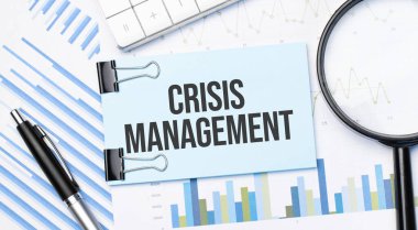 Top view of tex crisis management with calculator, magnifying glass and pen on financial charts . Business, calculation, strategy, searching and tax concept. Top view.