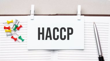 text hacccp on stickers on the diary with office tools