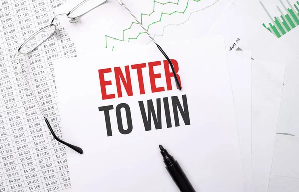 Enter to Win . Conceptual background with chart ,papers, pen and glasses