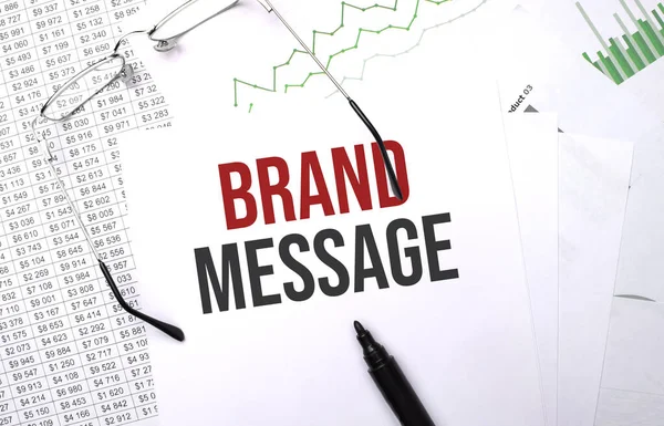 BRAND MESSAGE . Conceptual background with chart ,papers, pen and glasses