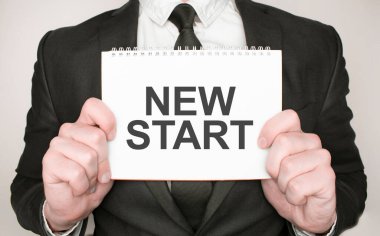 İş adamı elinde metni yeni başlayan bir not defteri tutuyor