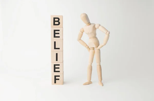 Wooden Mannequin Tower Cubes Word Belief Table Light Background — Stock fotografie