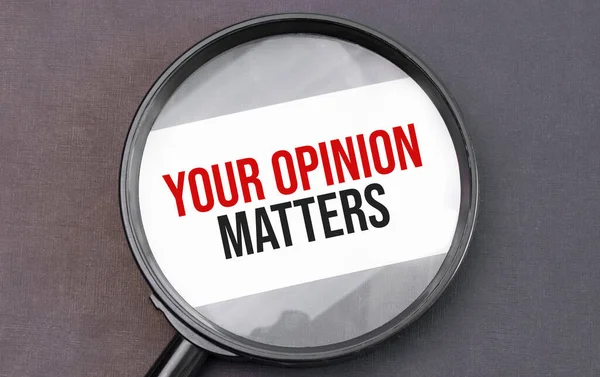 Your Opinion Matters word on paper through magnifying lens.