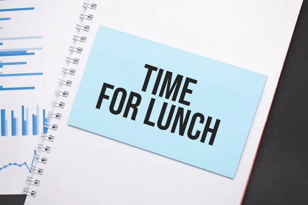 Paper plate with text TIME FOR LUNCH. Diagram, notepad and blue background