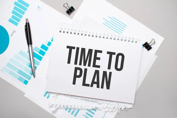 Paper plate with text TIME TO PLAN. Diagram, notepad and blue background