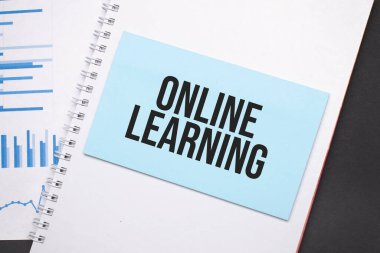 Yazılı kağıt tabak, online öğrenme. Diyagram, not defteri ve mavi arkaplan