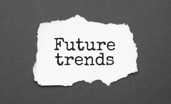 Future trends sign on the torn paper on the black background