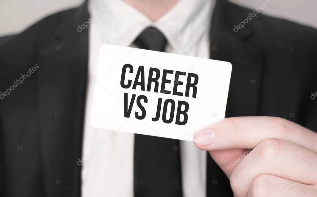 Businessman holding a card with text Career vs Job