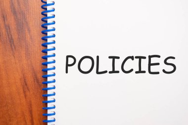 Not defterinde yazılı metin politikaları, yukarıdan ofis ahşap tablosu, blog başlığı veya başlık resmi konsepti. Yıllanmış vintage rengi görünümü.