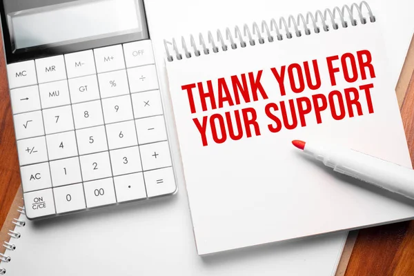 Notepad with text Thank you For Your support on wooden background with calculator and red marker