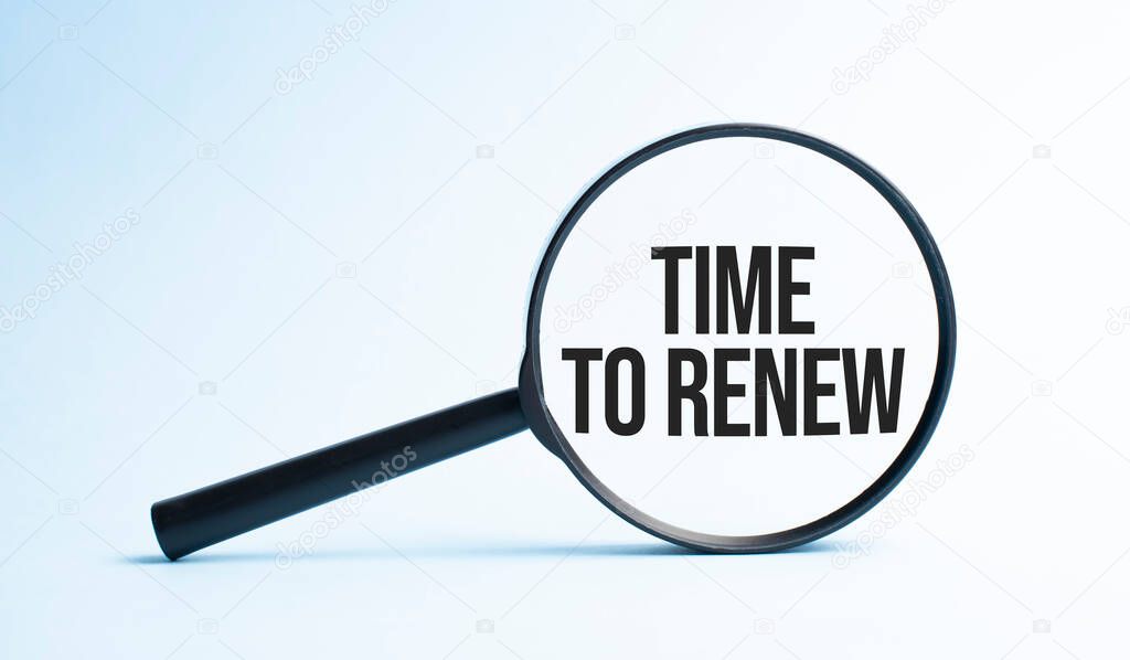 Magnifying glass with the word Time to renew. Business concept