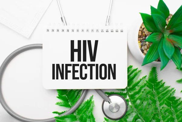 HIV infection word on notebook,stethoscope and green plant