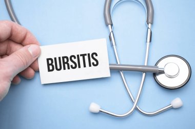 the doctor's hands holds a business card with the text of Bursitis with one hand and the other points to the text.