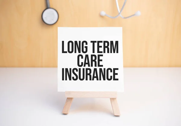 Long Term Care Insurance sign on small wood board rest on the easel with medical stethoscope