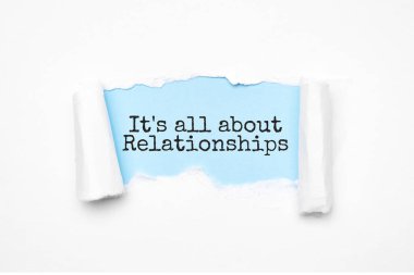 Concept of discovering it's all about relationships. Uncovered unrolled beige torn paper and search engine optimization abbreviation.