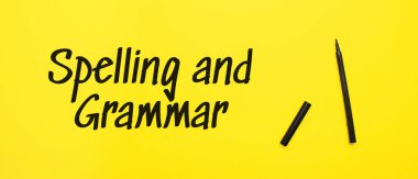 Spelling and Grammar sign with black marker on a yellow background. With copy space ready for your text.