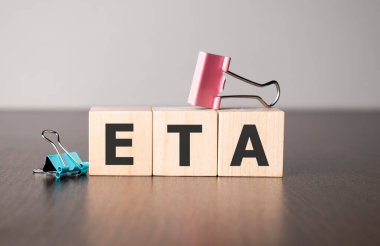 Businesswoman made word eta with wood building blocks.