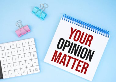 White future calculator, paper sheet, pink paper clips and silver colored pen. Text Your Opinion Matter