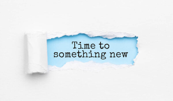 The text Time to something new appearing behind torn yellow paper