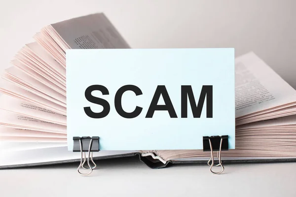 White Card Text Scam Stands Clip Papers Table Background Books — Stock Photo, Image