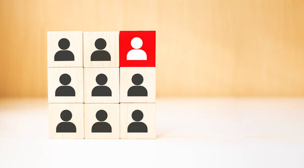 people icons with a light bulb on cube wooden toy blocks stacked.