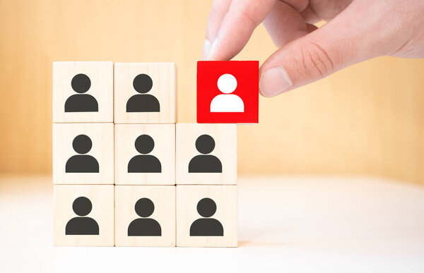 Human resource management and recruitment business concept, Hand putting wood cube block on top pyramid, Copy space