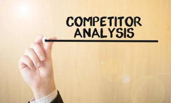 Hand writing inscription COMPETITOR ANALYSIS, with marker,business concept