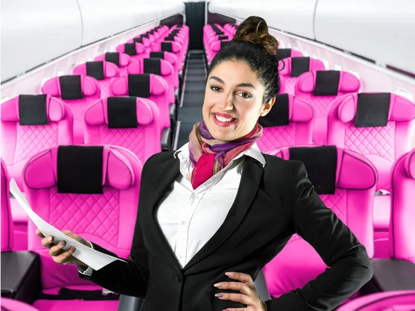 A beautiful flight attendant in a black jacket and mask in front of an airplane aisle. Subject on blurred background, perfect shot for commercial, pandemic, virus, quarantine, women at work.