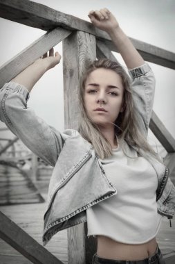 Güzel sarışın bir yaz gününde dışarıda poz veriyor.