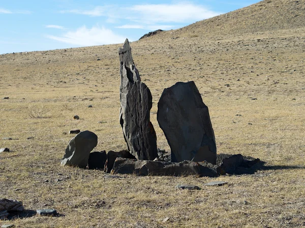 Two balbals with stone fences in steppe, sacred place.