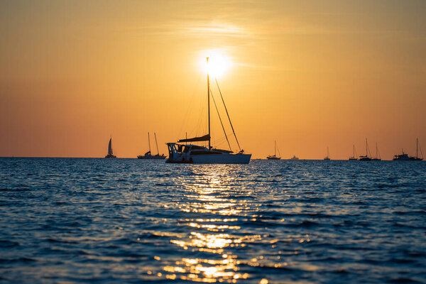 Sailing boats at Vesteys beach at sunset.