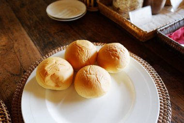 Fresh homemade bread rolls in white plate for breakfast