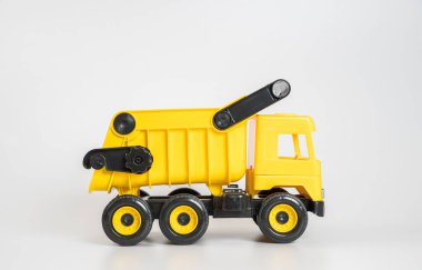Plastik araba. Oyuncak modeli beyaz arka planda izole edilmiş. Sarı kamyon..