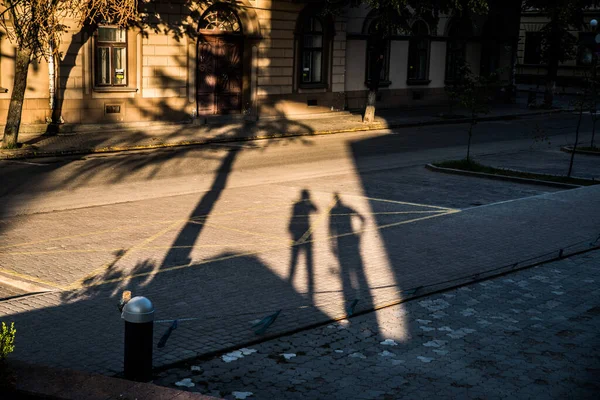 People shadow on the pavement