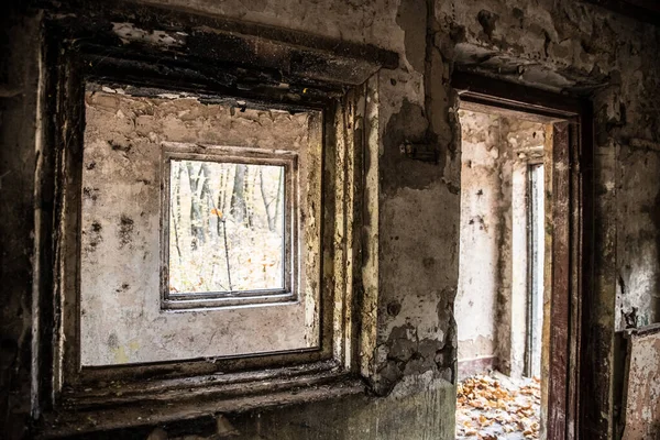 Windows in an old abandoned room with old cracked plaster.