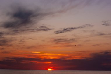 Sakin Deniz Ufkunda Dramatik Kızıl Gün Batımı